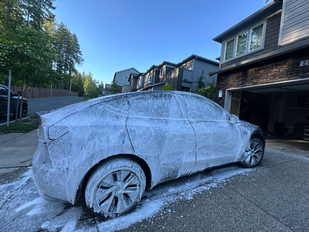 Professional foam wash process showing exterior cleaning