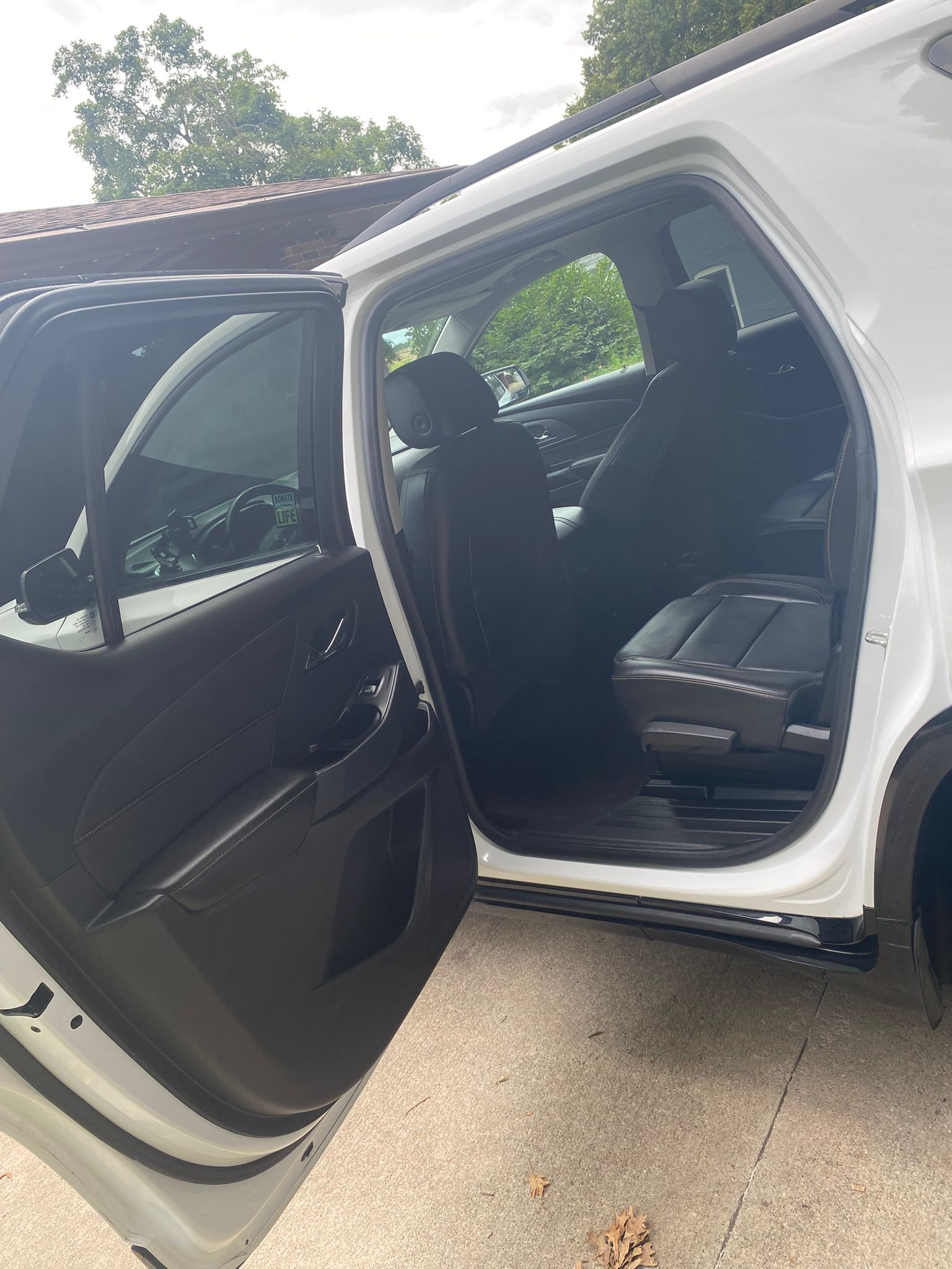 White vehicle with open doors showing clean interior